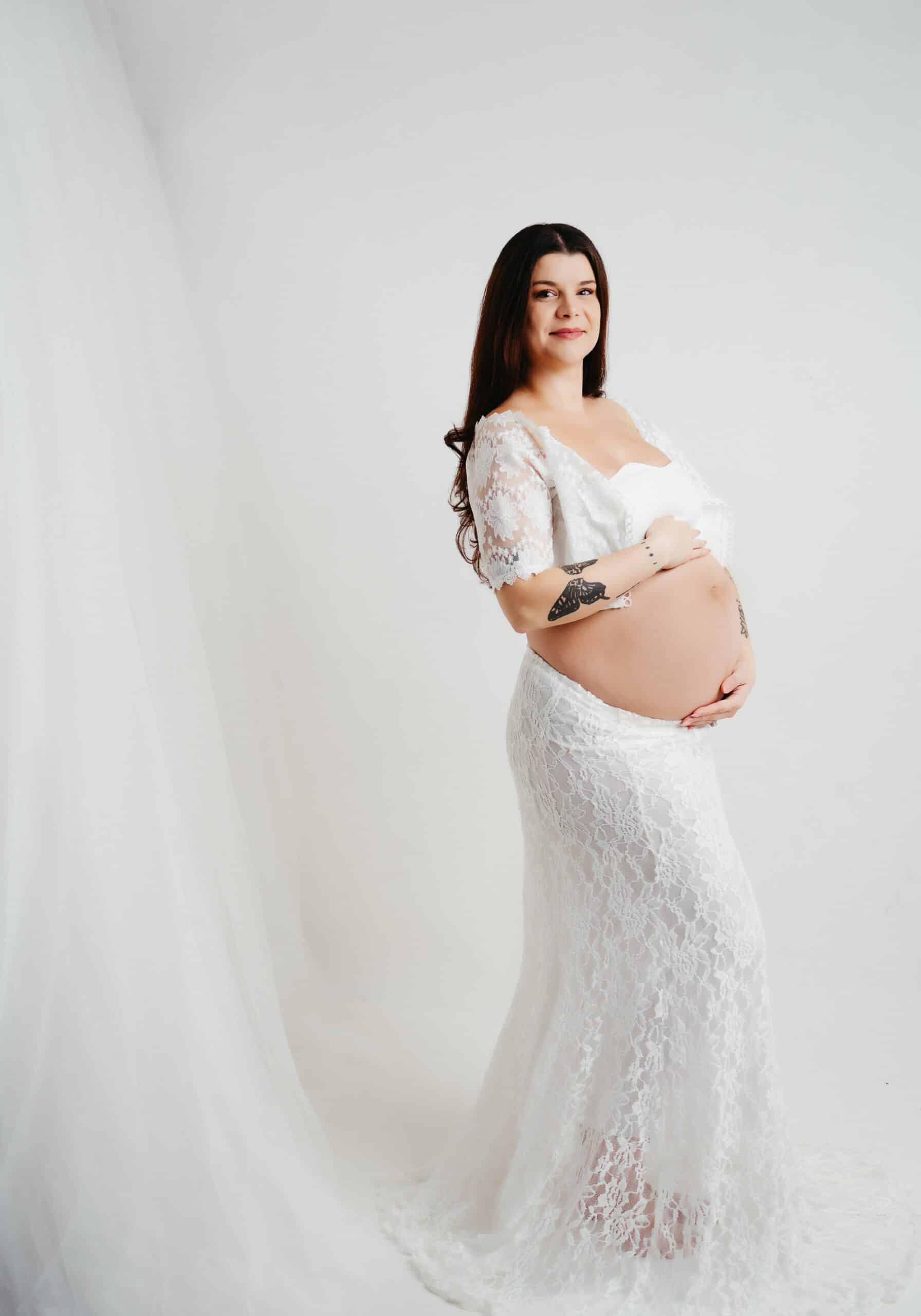Serene white maternity session featuring a peaceful expectant mother in a clean and bright setting, highlighting the purity and tranquility of this special moment