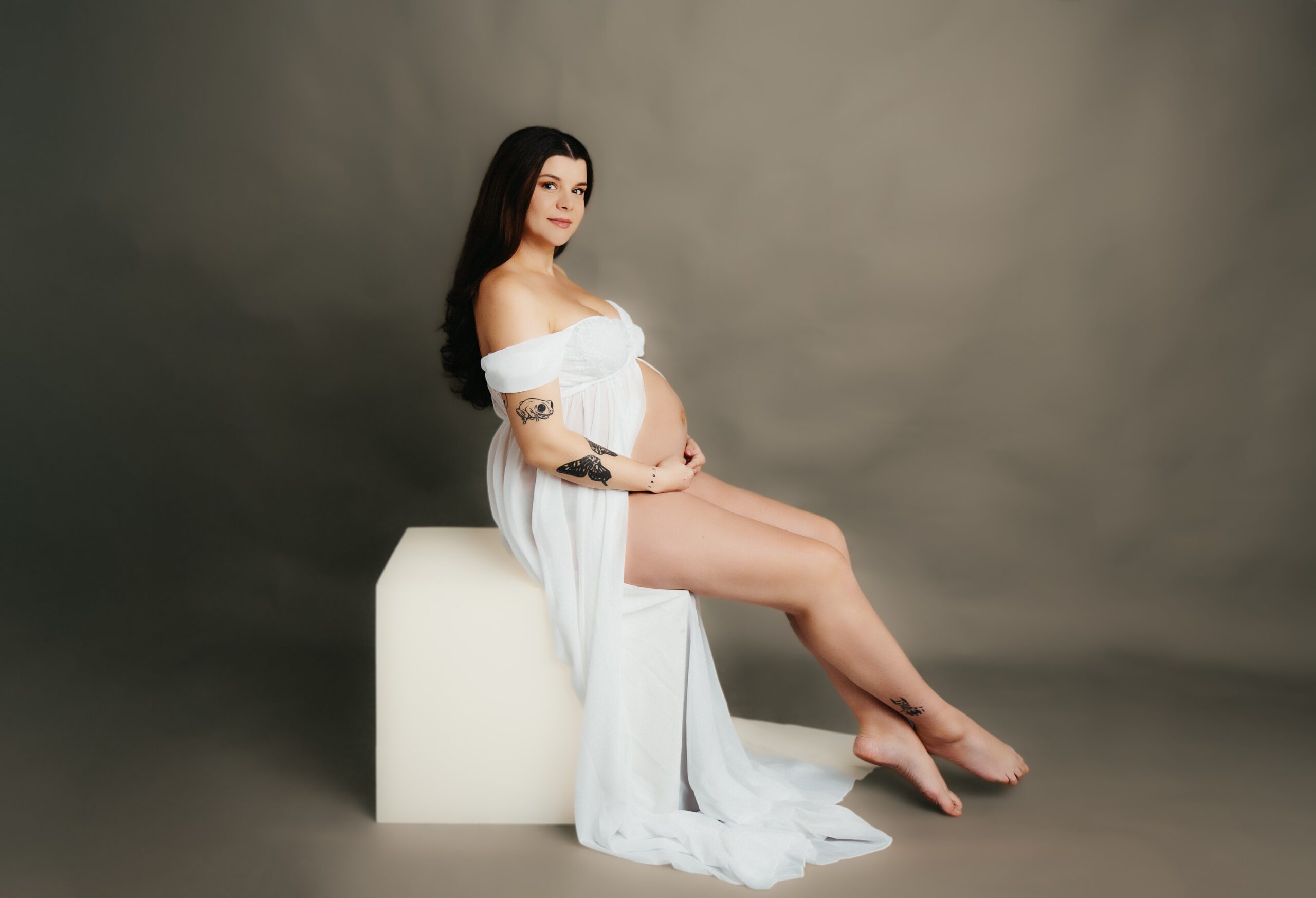 Expectant woman with a vintage flair, gazing confidently into the camera against a warm copper background, capturing the timeless beauty of maternity in a classic setting